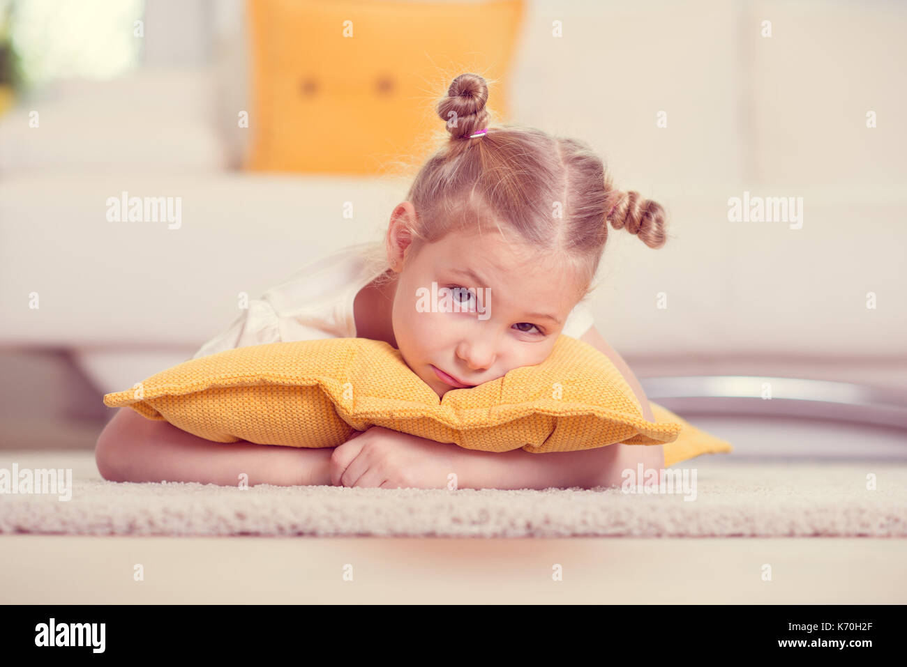 Cute little girl lying on floor at home Stock Photo - Alamy