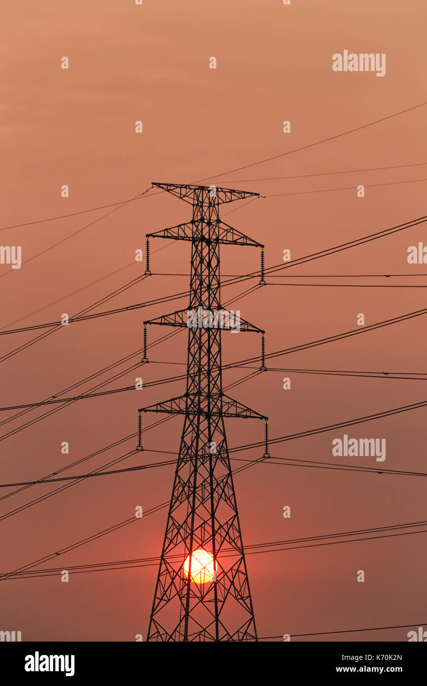 High voltage towers and sunset in Energy concept,Photography Silhouette. Stock Photo