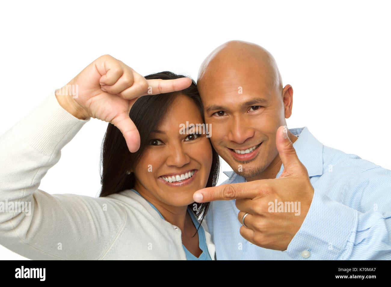 Asian couple making picture hand gestures. Stock Photo