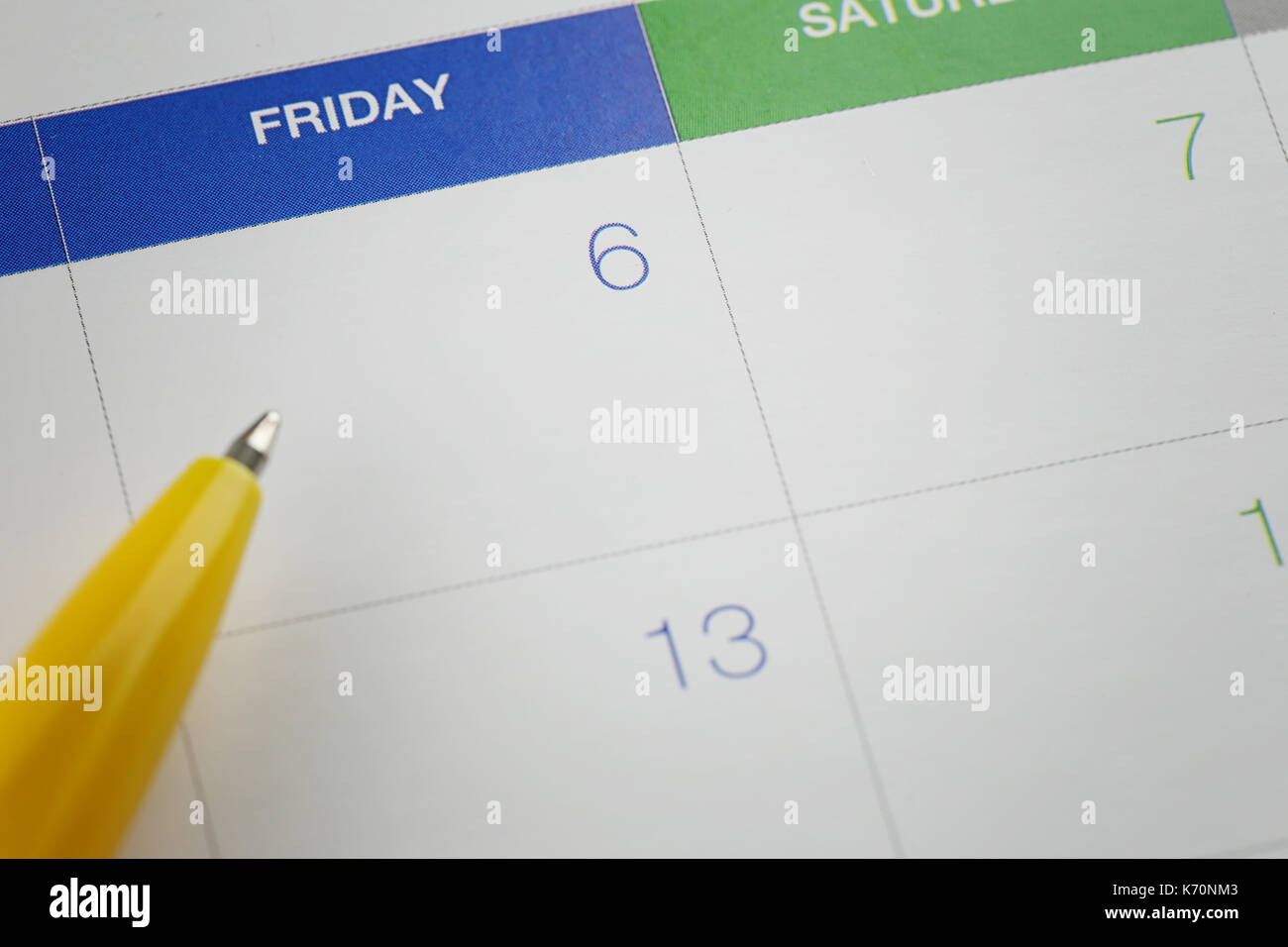 yellow pen points to the number 6 on calendar background in concept of appointment schedules and important dates. Stock Photo