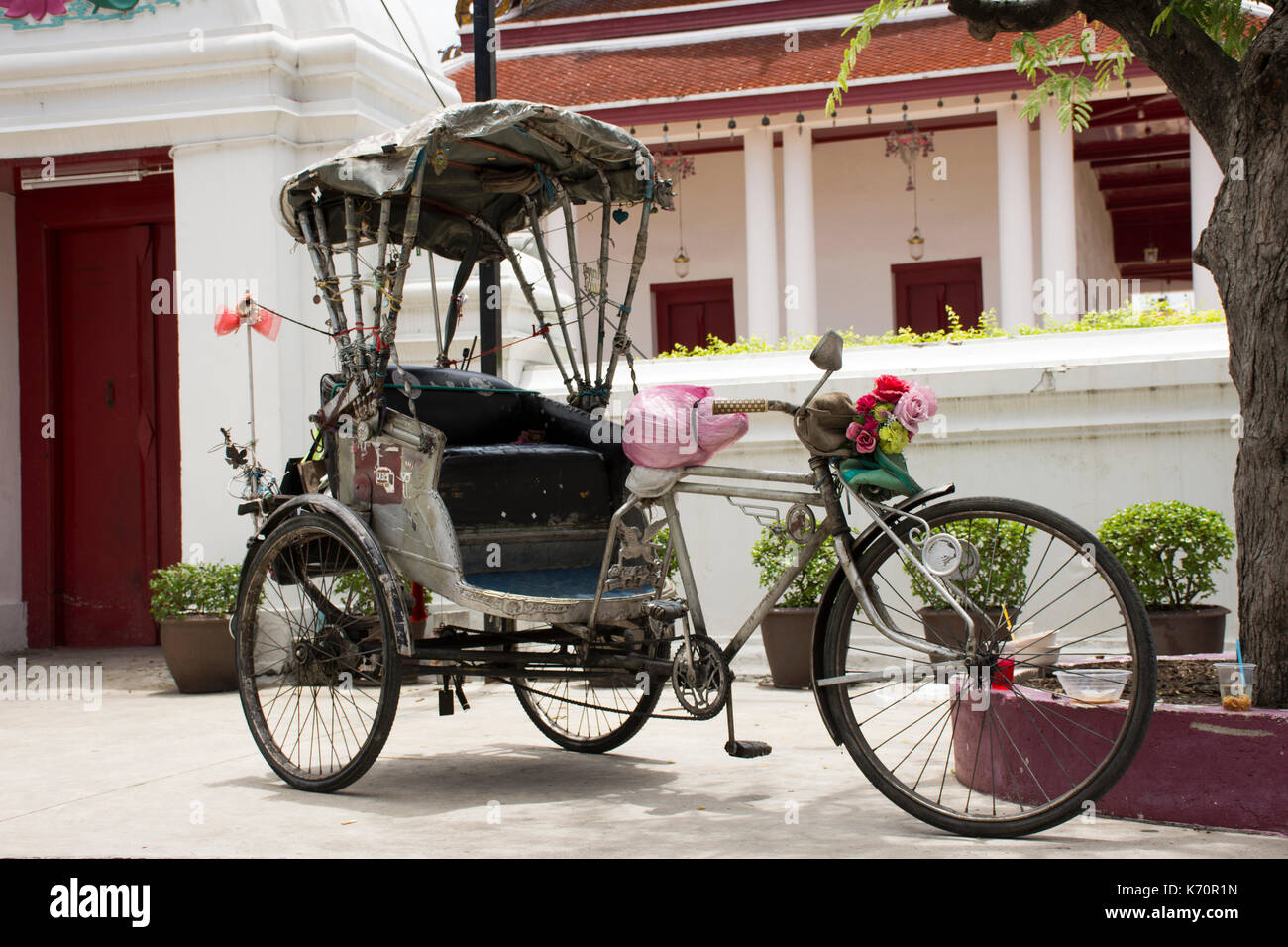 Vintage retro tricycle bike or rickshaw of thai style at front of gate ...