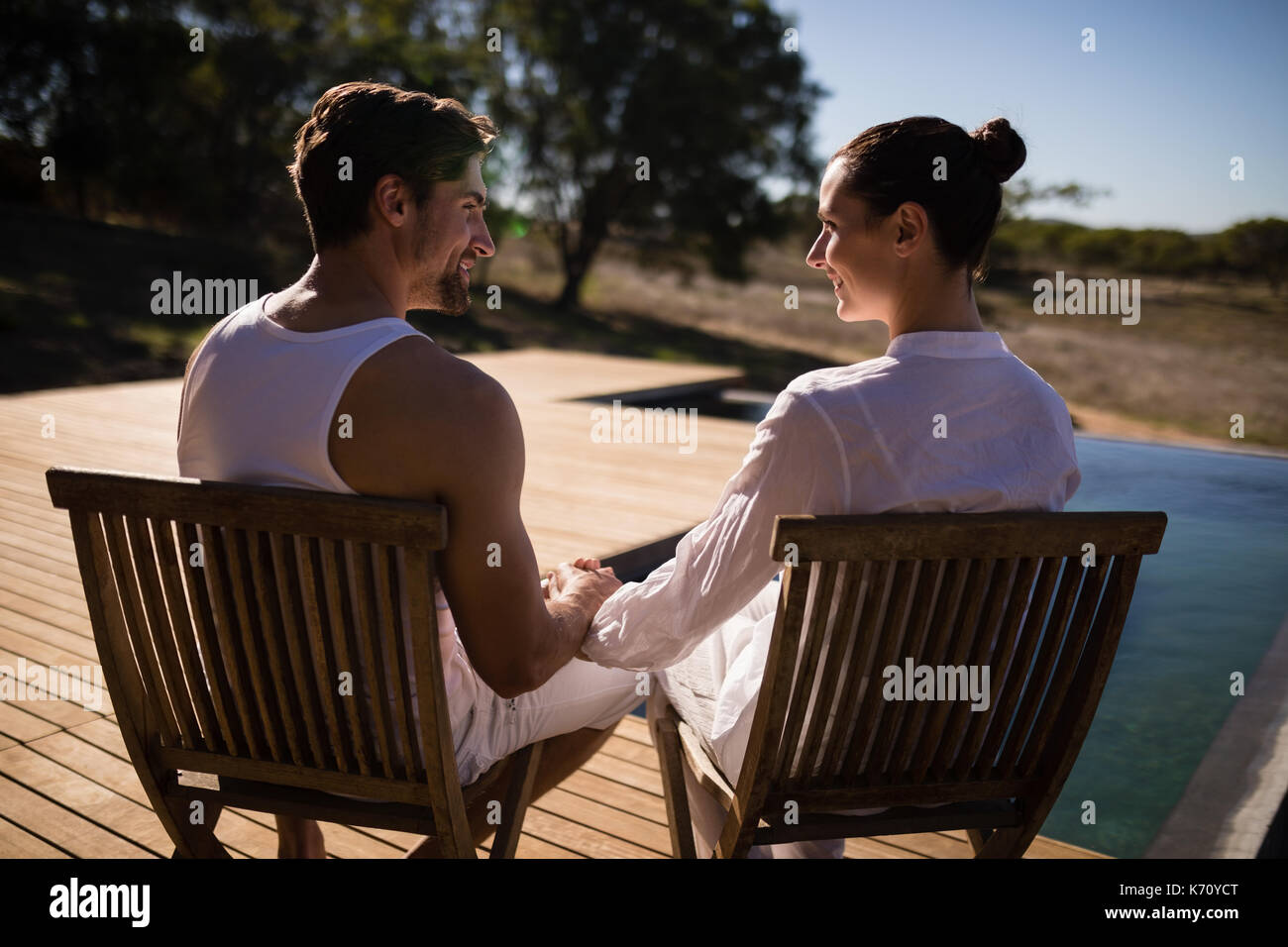 Romantic couple sitting on chair hires stock photography and images