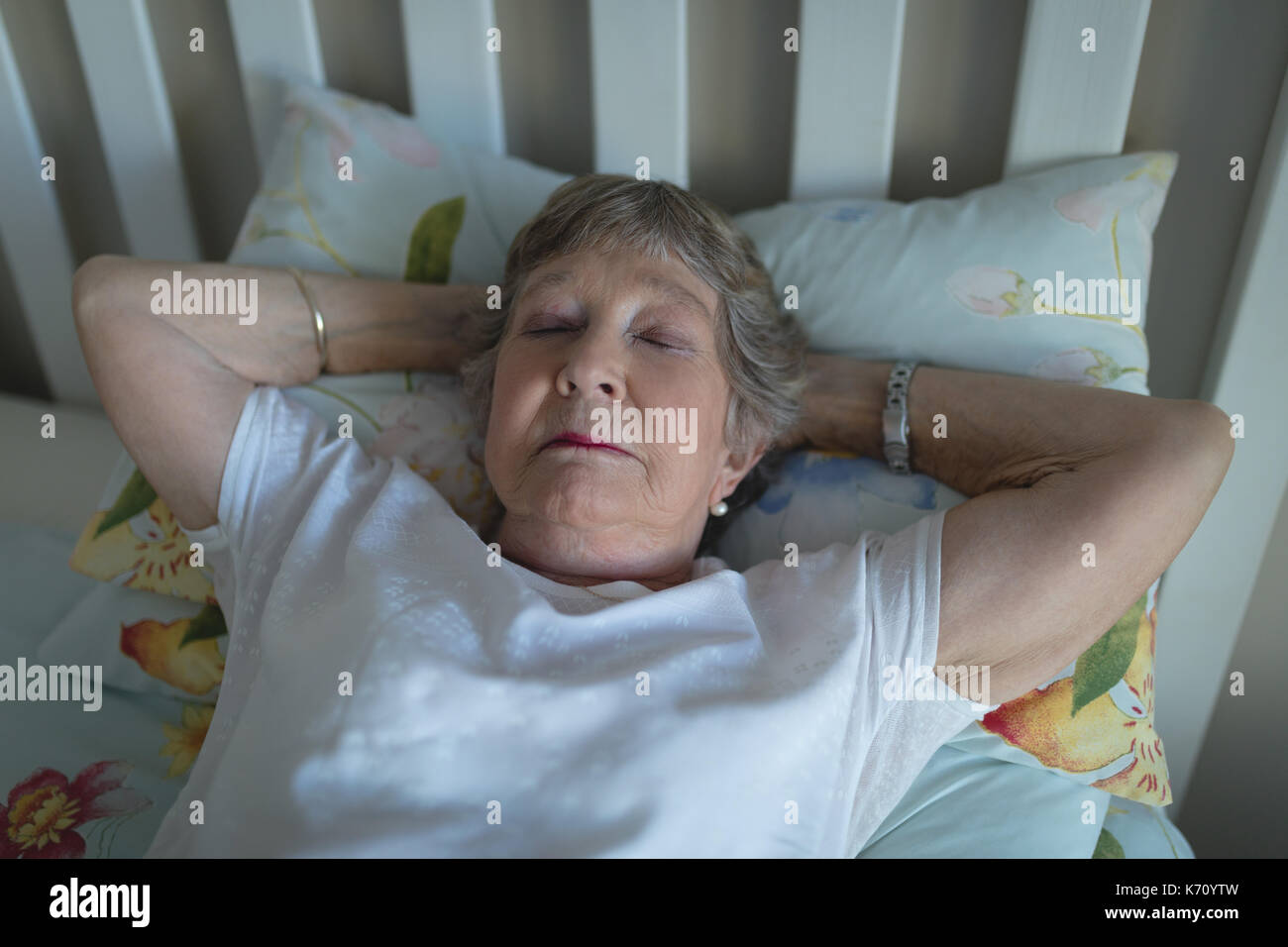 Senior woman sleeping on bed in bedroom at home Stock Photo Alamy