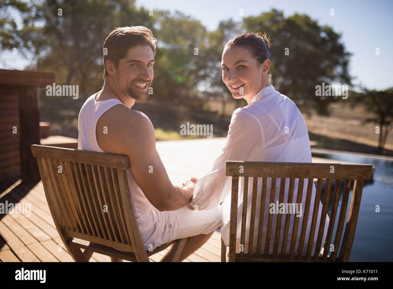Romantic couple sitting on chair hires stock photography and images