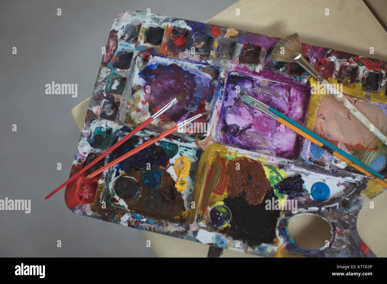 Paintbrushes on palette in art studio Stock Photo