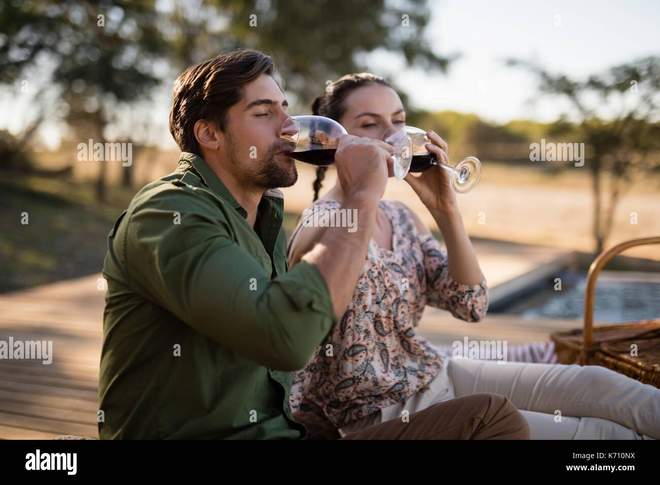 Romantic couple drinking red wine during safari vacation Stock Photo