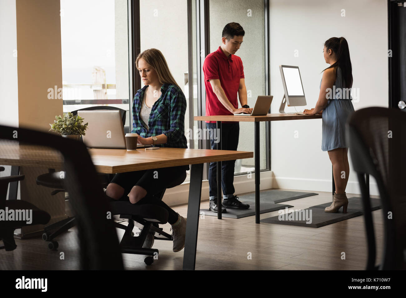 Business people using technologies at table in creative office Stock Photo