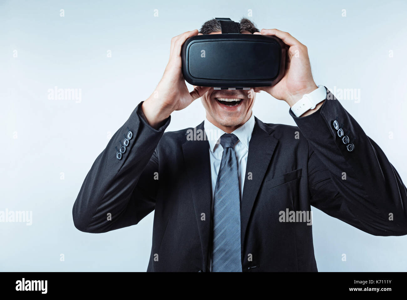 Amazed man of business trying on visual reality headset Stock Photo