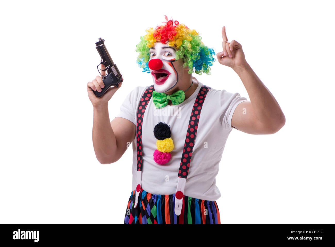 Funny clown with a gun pistol isolated on white background Stock Photo