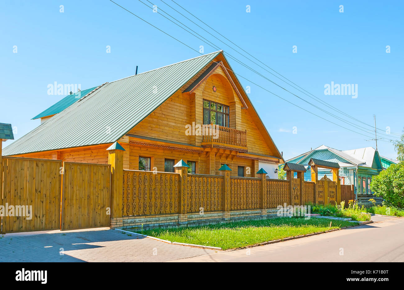 The scenic carved fence and gate created in classic Russian traditions ...