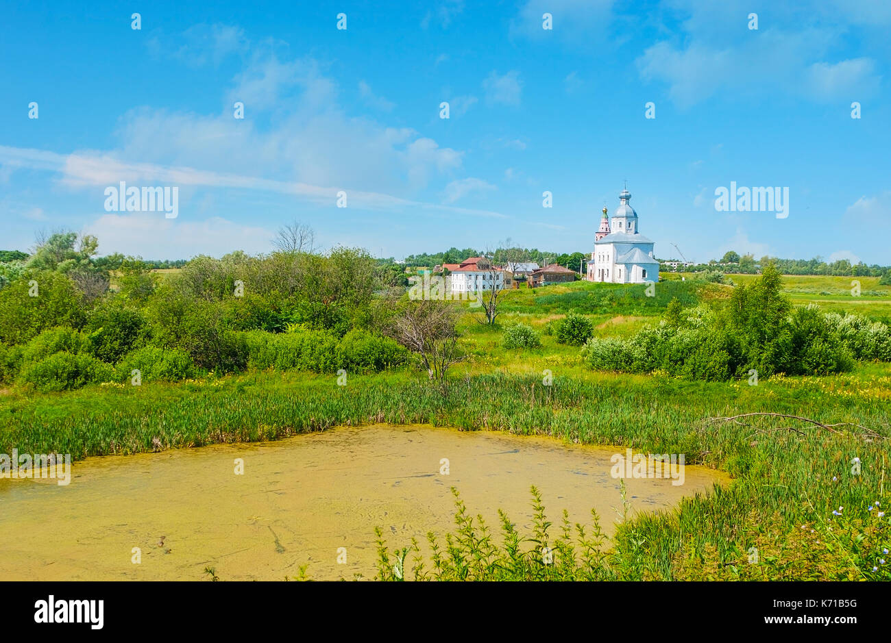 The church of Ilya the Prophet is seen behind the tiny pond on Ilinskiy meadow in Suzdal, Russia. Stock Photo