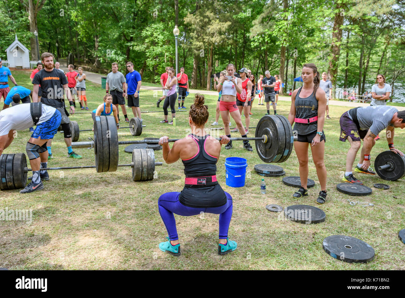 Woman competing in the Combat on the Coosa fitness challenge in Wetumpka, Alabama, United States, lifting heavy weights. Stock Photo