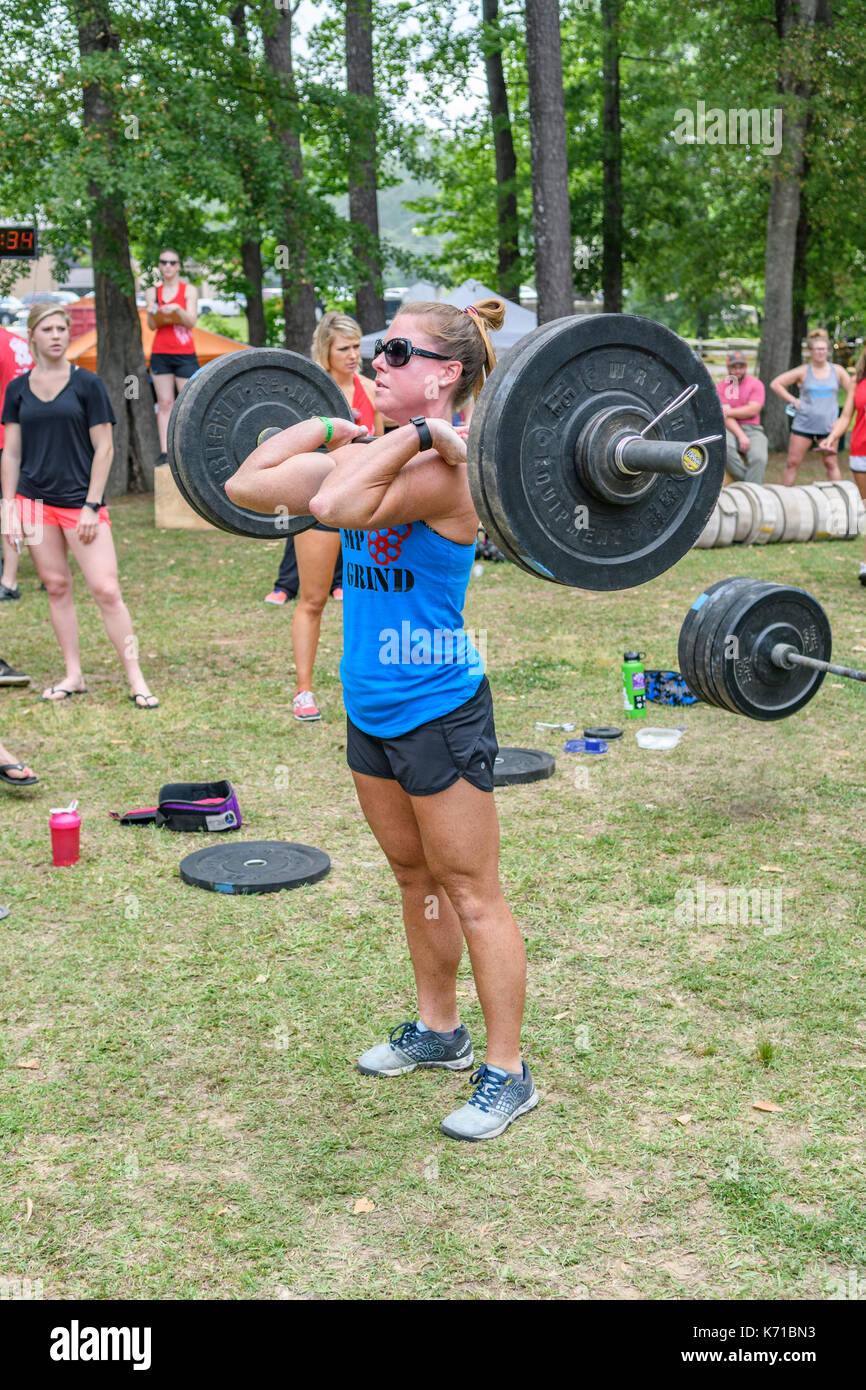 Woman competing in the Combat on the Coosa fitness challenge in Wetumpka, Alabama, United States, lifting heavy weights. Stock Photo