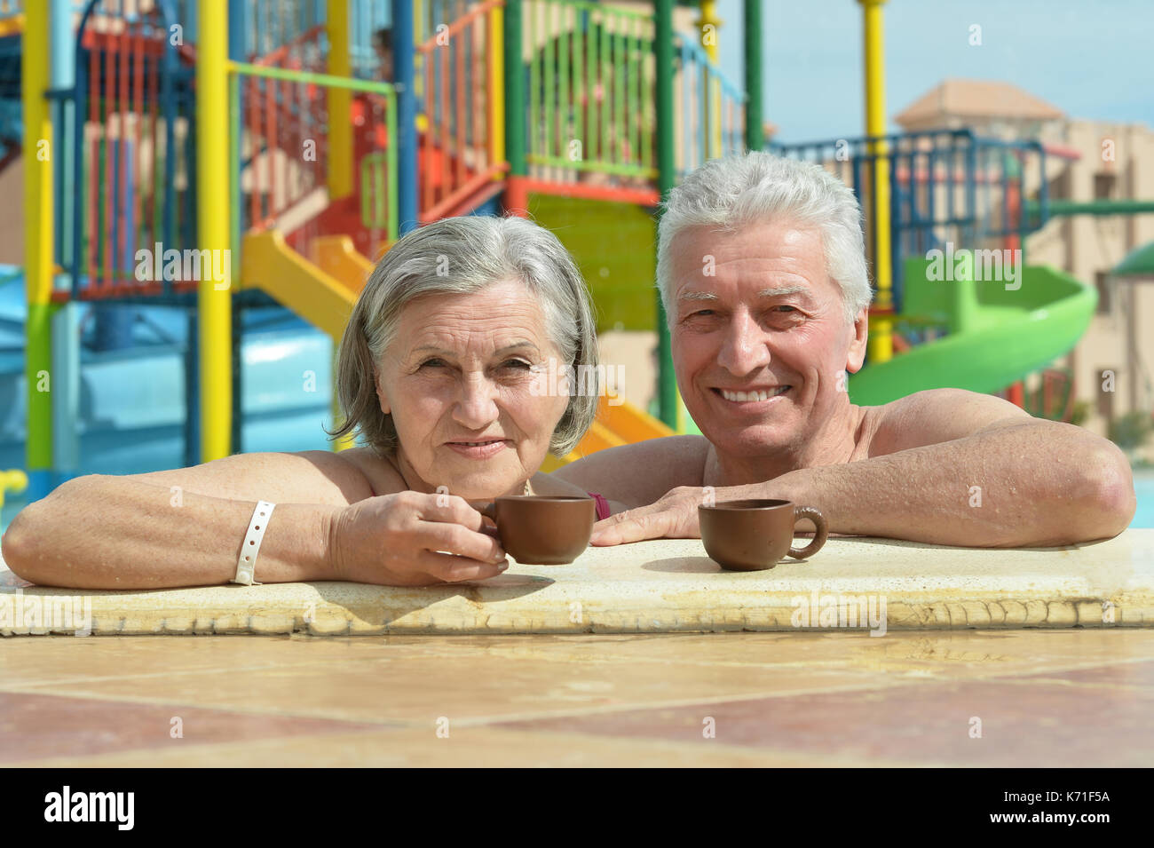 Senior couple relaxing at pool Stock Photo - Alamy