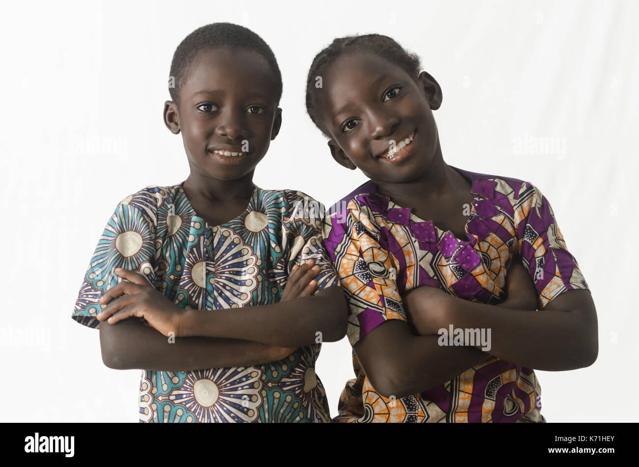 Two awesome African children posing with arms crossed, isolated on white Stock Photo