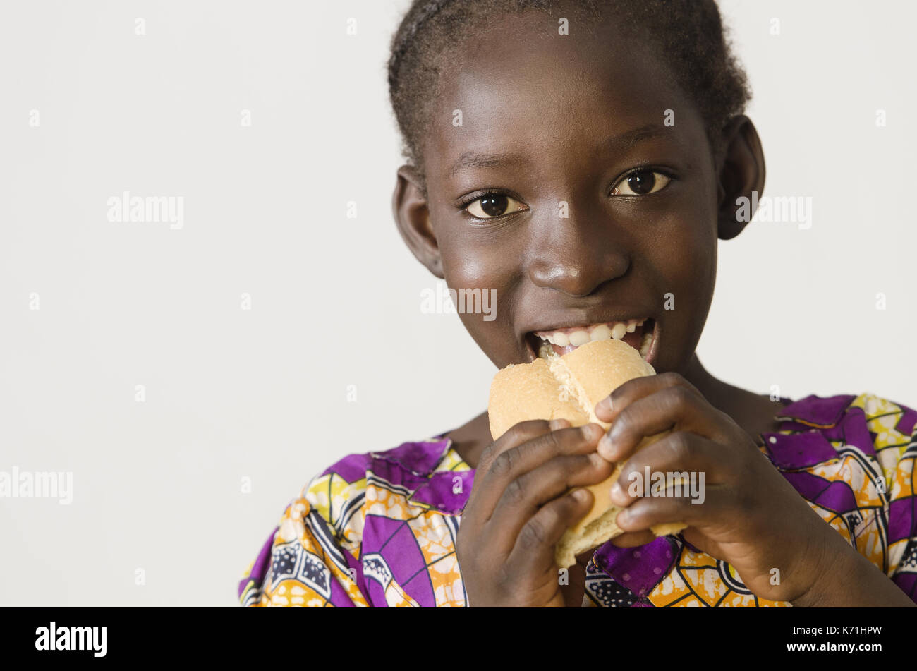 https://c8.alamy.com/comp/K71HPW/young-african-girl-eating-some-bread-isolated-on-white-K71HPW.jpg
