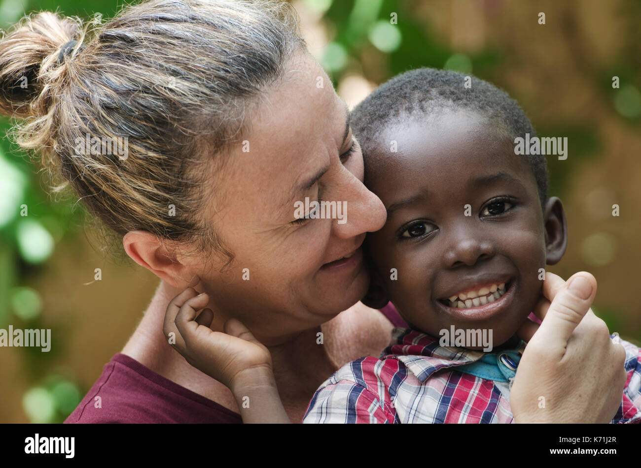 Portrait of European woman with a black African boy Stock Photo
