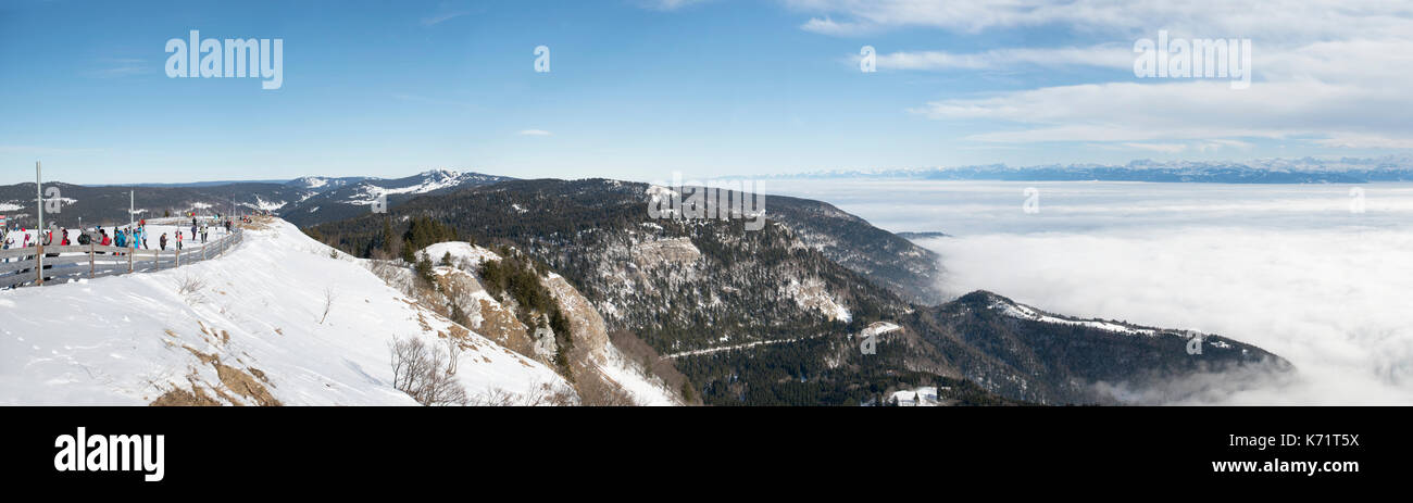 Skiers on Mont Rond looking over could covered Lake Geneva, Jura mountains, France Stock Photo