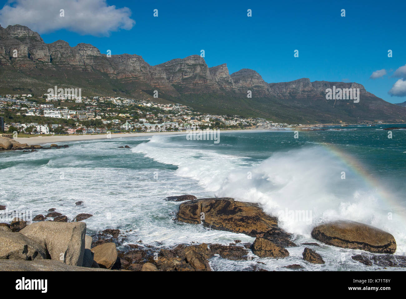 Panoramic view of Camp's Bay with surf and tweleve apostels mountains, Cape Town, Western Cape, South Africa Stock Photo