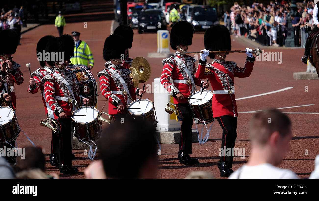 Queen's Guards soldiers marching on the street in front of the Buckingham Palace during the Guard Change, London, UK Stock Photo