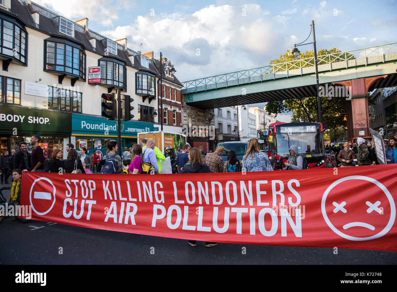 London, UK. 14th Sep, 2017. Environmental activists from Stop Killing Londoners and Mums for Lungs block Brixton Road in front of Brixton station at rush hour as part of a protest demanding urgent attention to prevent premature deaths from air pollution. Levels of nitrogen dioxide, linked to 9,500 early deaths a year in London, recorded in Brixton Road have repeatedly breached the EU limit. Credit: Mark Kerrison/Alamy Live News Stock Photo
