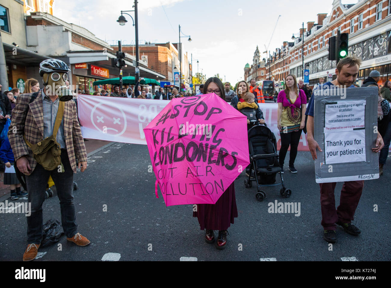 London, UK. 14th Sep, 2017. Environmental activists from Stop Killing Londoners and Mums for Lungs campaign block Brixton Road in front of Brixton station at rush hour as part of a protest demanding urgent attention to prevent premature deaths from air pollution. Levels of nitrogen dioxide, linked to 9,500 early deaths a year in London, recorded in Brixton Road have repeatedly breached the EU limit. Credit: Mark Kerrison/Alamy Live News Stock Photo