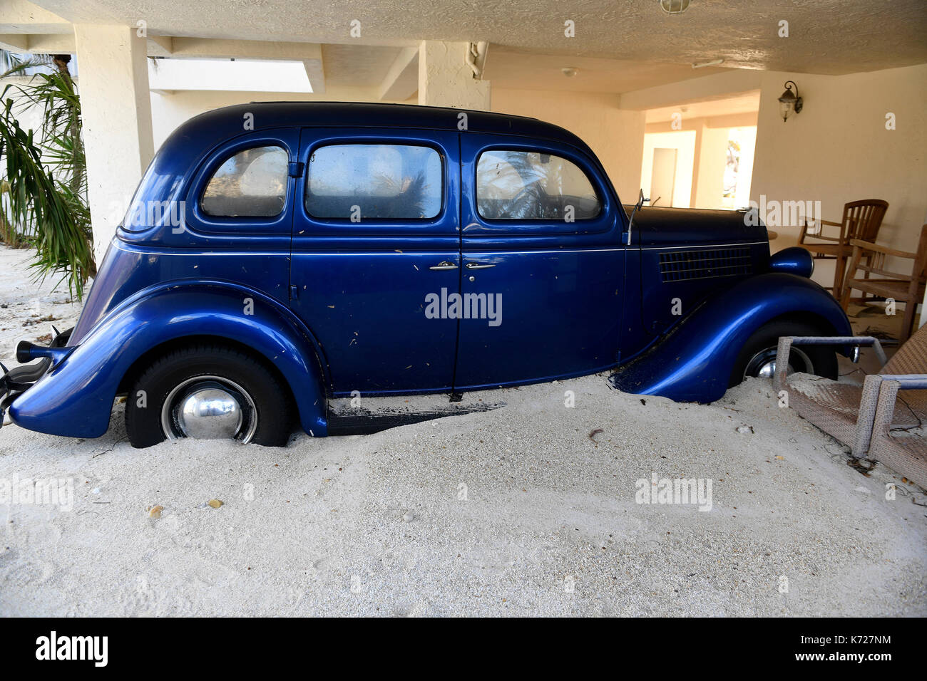 September 14, 2017 - Tavernier, Florida, U.S.- The home of former Dolphins and University of Miami football coach Jimmy Johnson was destroyed by Hurricane Irma. Several feet of sand was pushed onto his property and into his home destroying collectibles, this antique car and severly damaging the whole property. Credit: Taimy Alvarez/Sun-Sentinel/ZUMA Wire/Alamy Live News Stock Photo