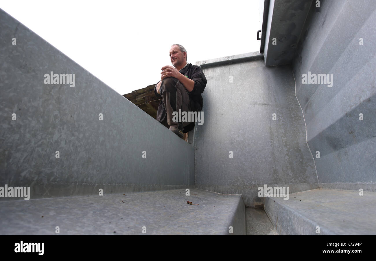 Missen, Germany. 21st Aug, 2017. Farmer Herbert Siegel sits on his mobile slaughtering station (German: 'Mobile Schlacht Box' or 'mobile slaugher box') in Missen, Germany, 21 August 2017. The station allows Siegel to slaughter his cows in the meadows in which they graze, thus sparing them the stressful journey to the slaugher house. Siegel is one of the few farmers to use such a device in Germany. Photo: Karl-Josef Hildenbrand/dpa/Alamy Live News Stock Photo