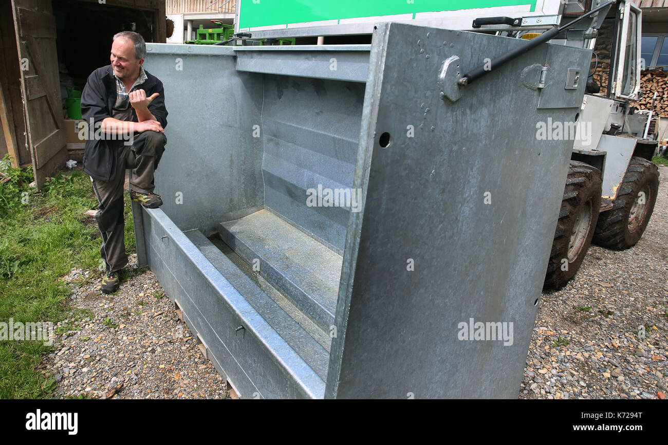 Missen, Germany. 21st Aug, 2017. Farmer Herbert Siegel sits on his mobile slaughtering station (German: 'Mobile Schlacht Box' or 'mobile slaugher box') in Missen, Germany, 21 August 2017. The station allows Siegel to slaughter his cows in the meadows in which they graze, thus sparing them the stressful journey to the slaugher house. Siegel is one of the few farmers to use such a device in Germany. Photo: Karl-Josef Hildenbrand/dpa/Alamy Live News Stock Photo