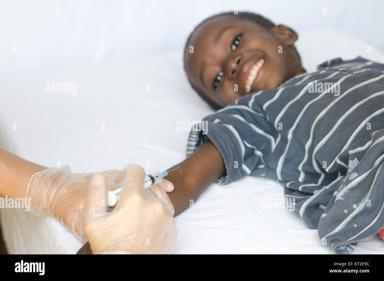 African black boy getting a vaccination from a white medical doctor Stock Photo