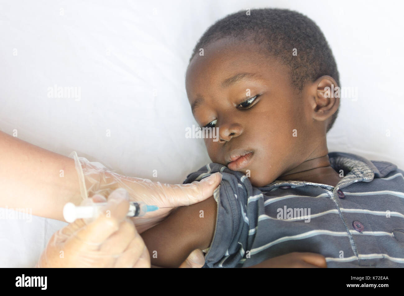 Healthcare and Medical symbol: african black boy gets a vaccination needle Stock Photo