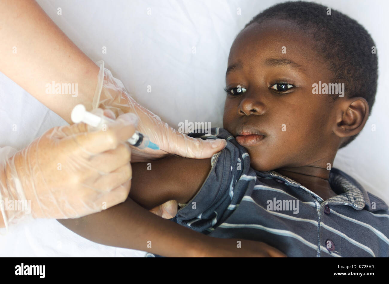 Vaccination for African children: little black boy getting an injection from a nurse Stock Photo