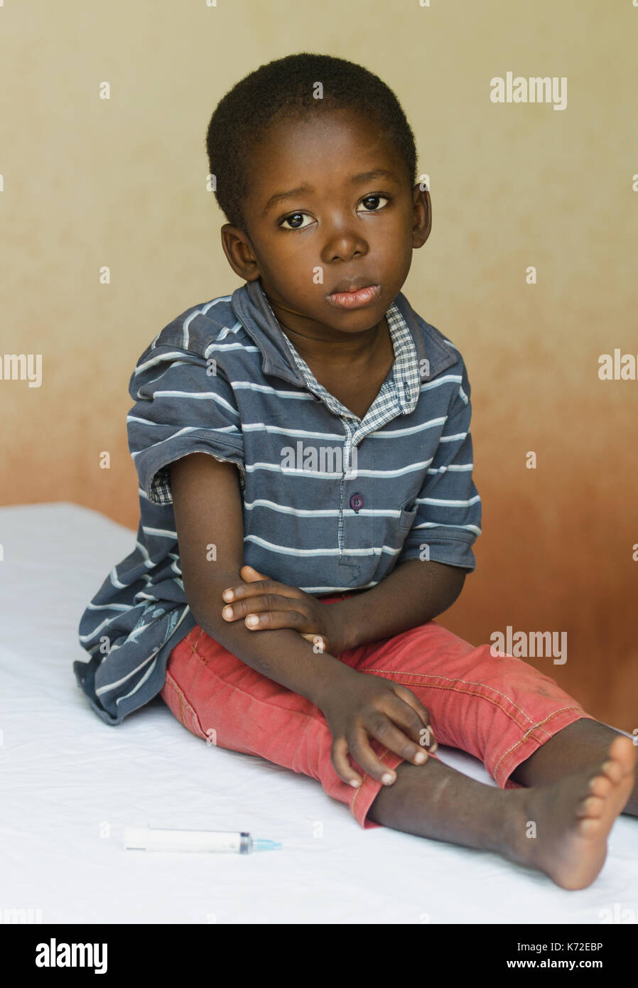 Little boy sitting in a hospital waiting to get an injection Stock Photo