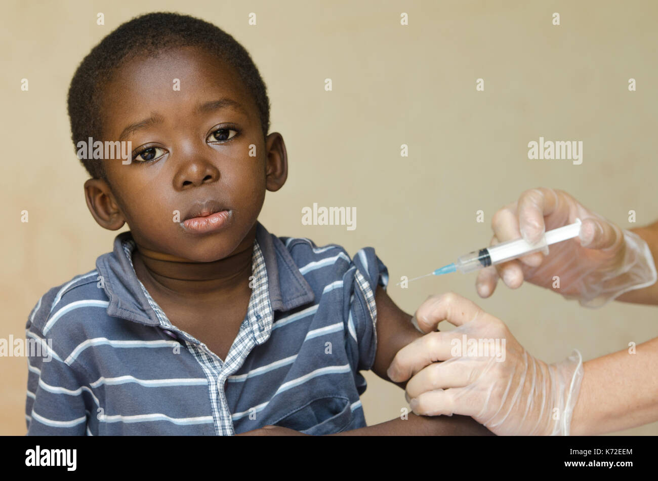 Polio Vaccination for African children from white volunteers in Africa Stock Photo