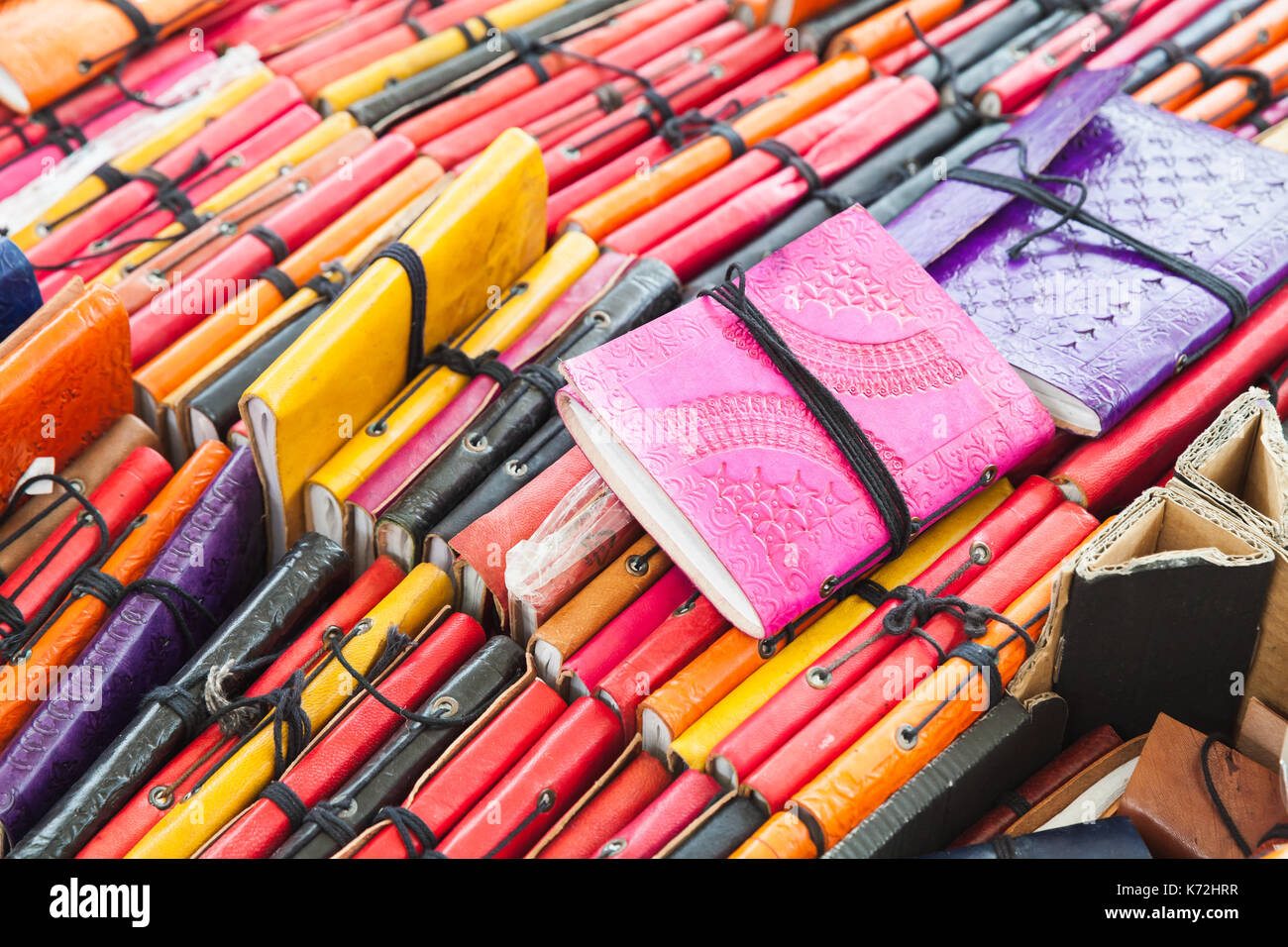 Amsterdam, Netherlands - February 25, 2017: Assortment of small notebooks in colorful leather covers. Goods of market Noordermarkt Stock Photo