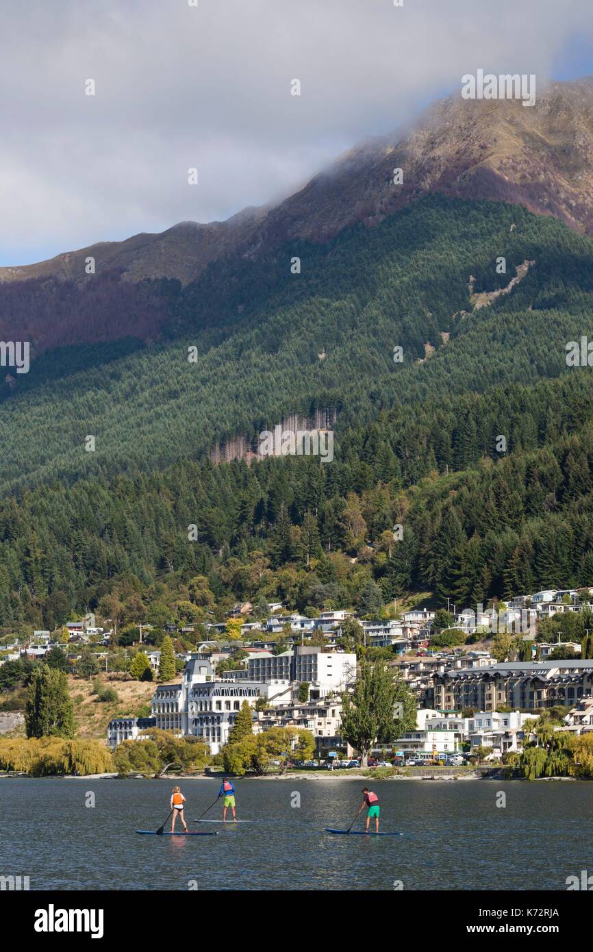 New Zealand, South Island, Otago, Queenstown, harbor view with board riders Stock Photo