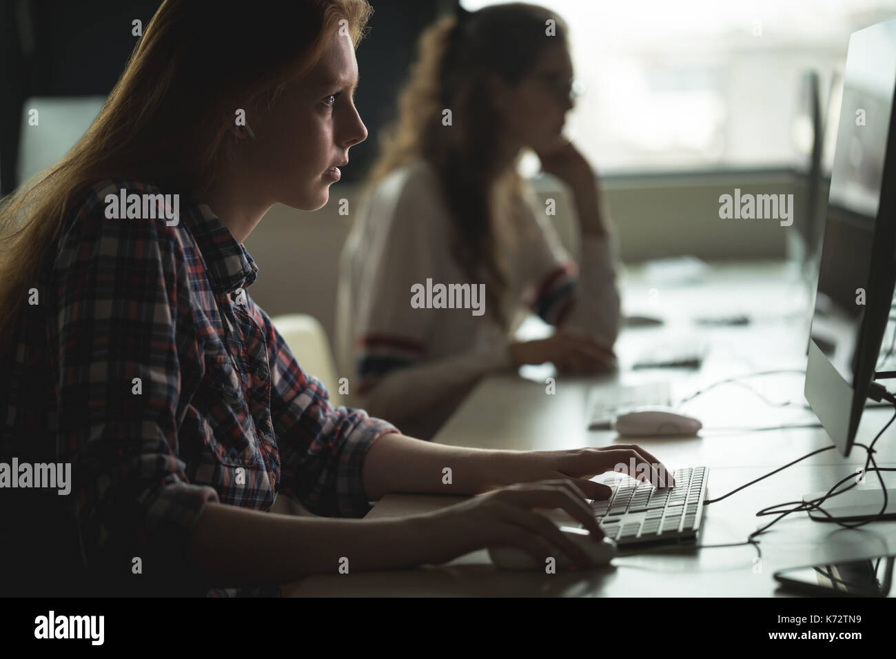 Beautiful women working on computer in college Stock Photo - Alamy
