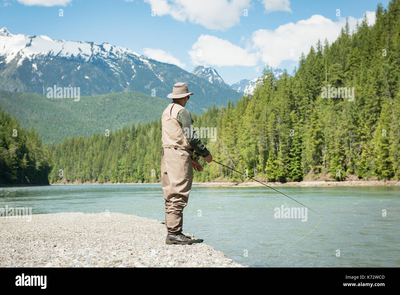 Young Man Fisherman bearded fishing with rod Lifestyle Travel survival  concept river on background Stock Photo - Alamy