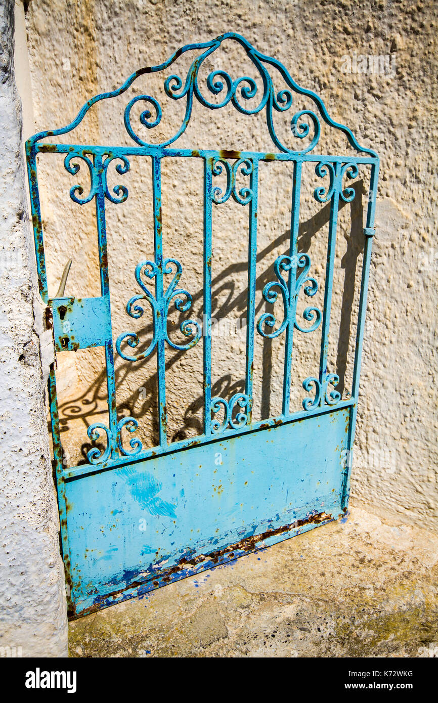 Rustic blue metal gate of abandoned building. Stock Photo