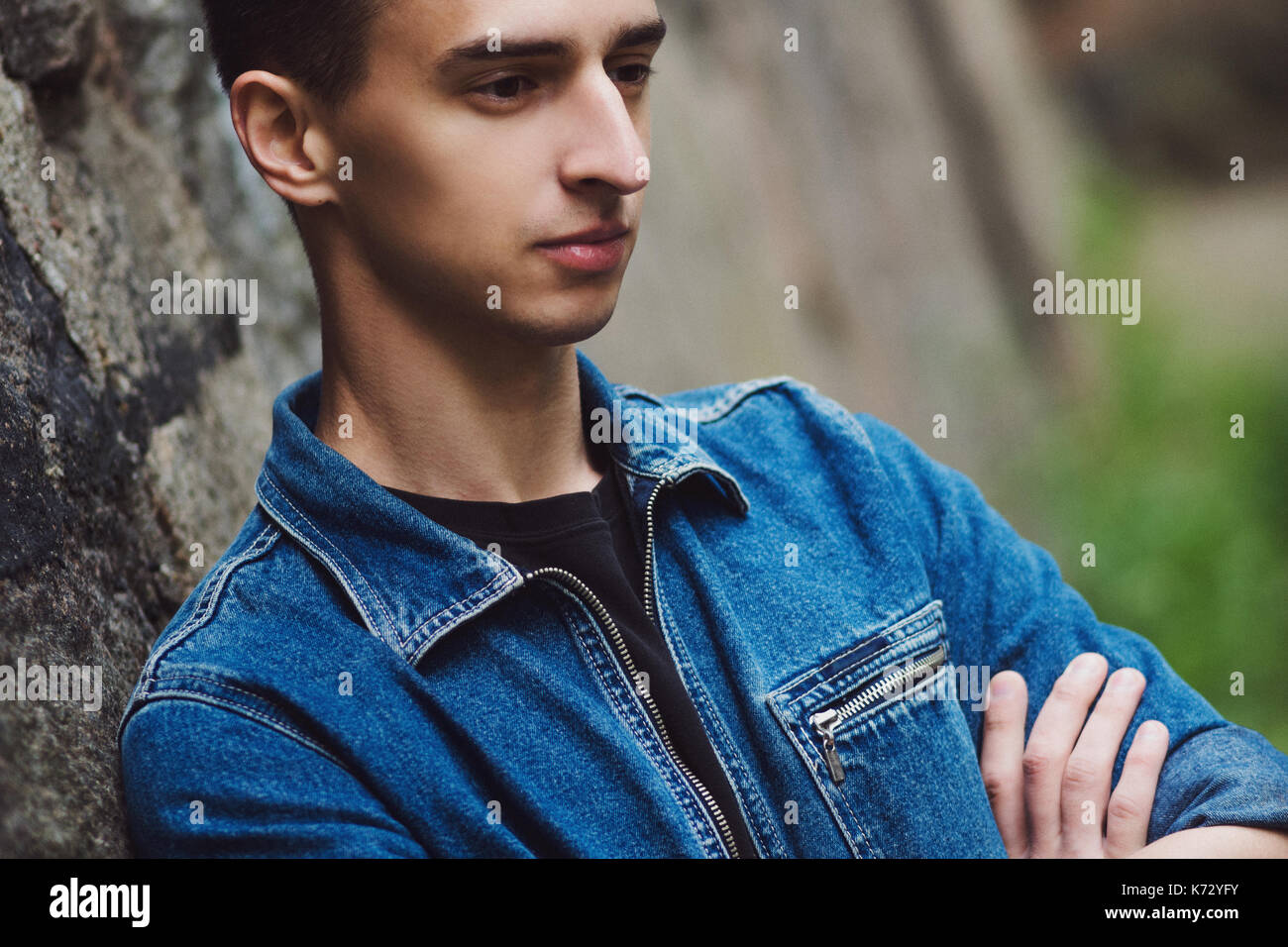 Brooding young guy in denim walks on the street Stock Photo Alamy Brooding young guy in denim walks on the street Stock Photo Alamy
