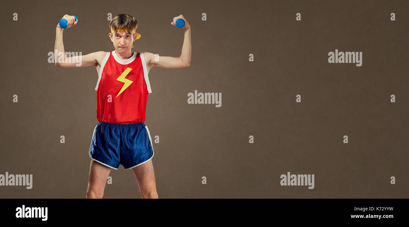 A thin funny guy in sports clothes with small dumbbells Stock Photo - Alamy