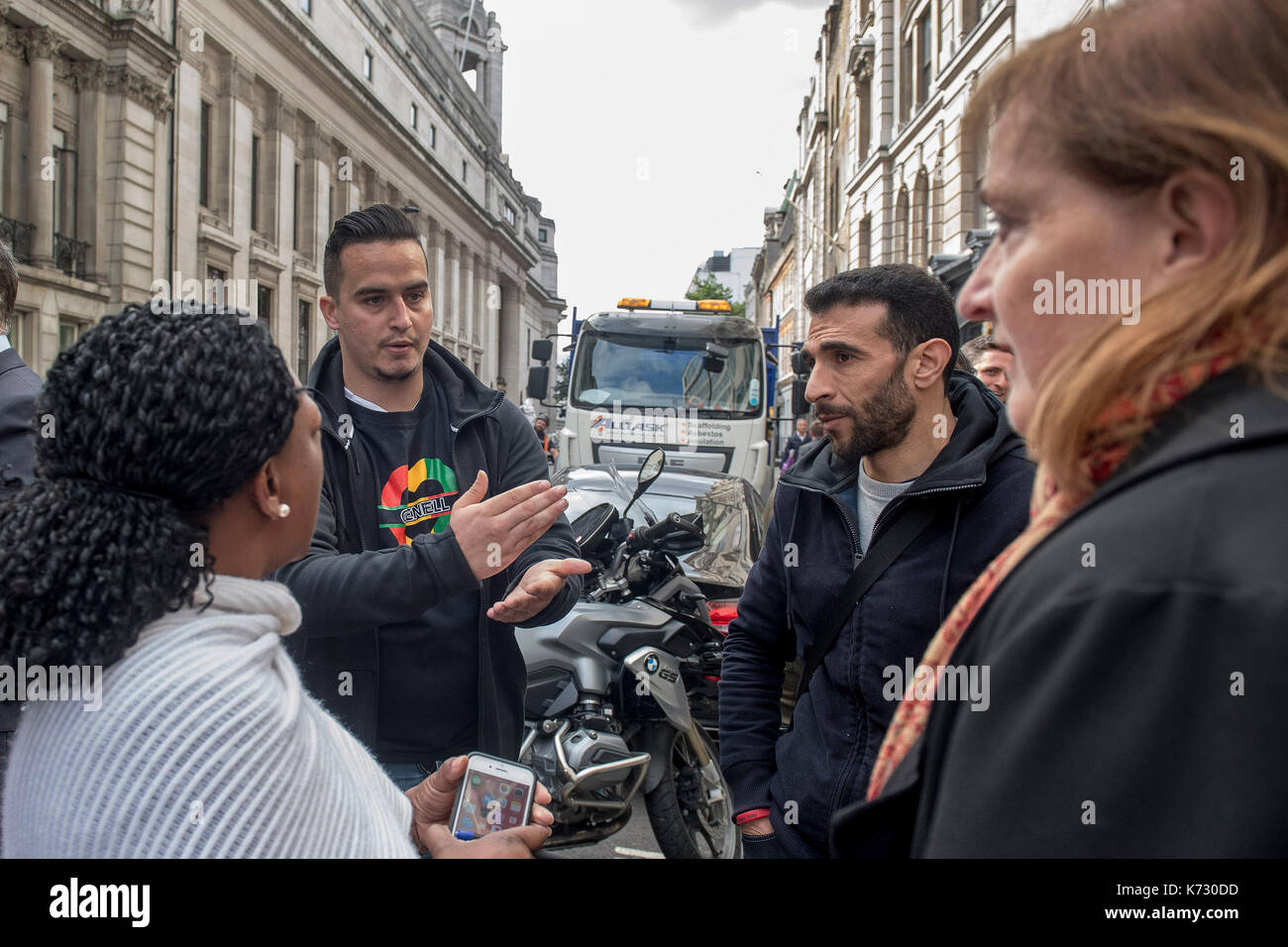 Paul Menacer (second left), Grenfell resident and survivor, criticises Emma Dent Coad (right), MP for Kensington, after the first preliminary hearing in the Grenfell Tower public inquiry, at the Connaught Rooms in central London. Stock Photo