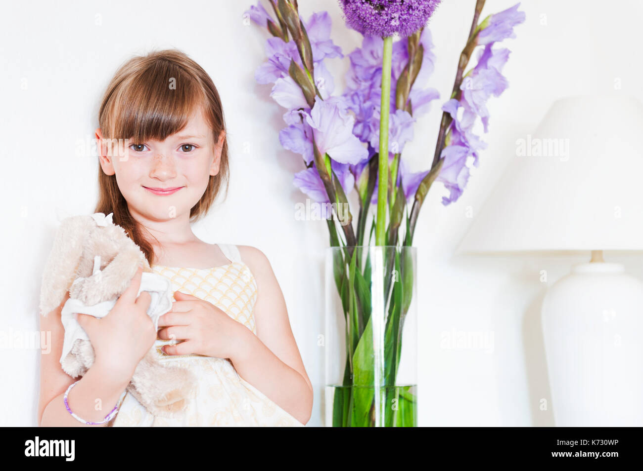 Interior portrait of a cute little girl with a toy Stock Photo - Alamy