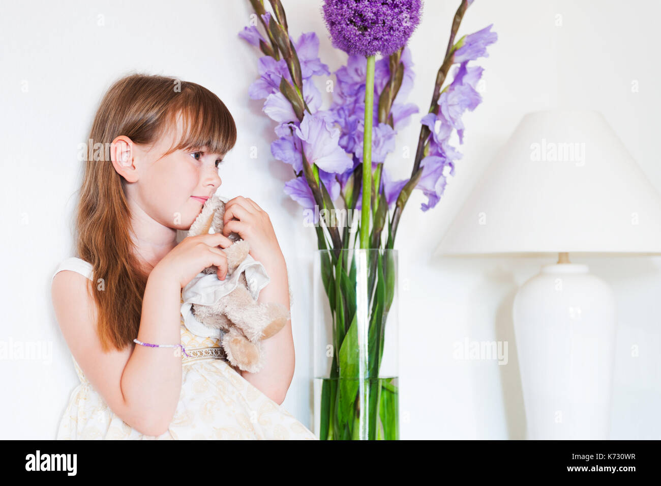 Interior portrait of a cute little girl with a toy Stock Photo - Alamy