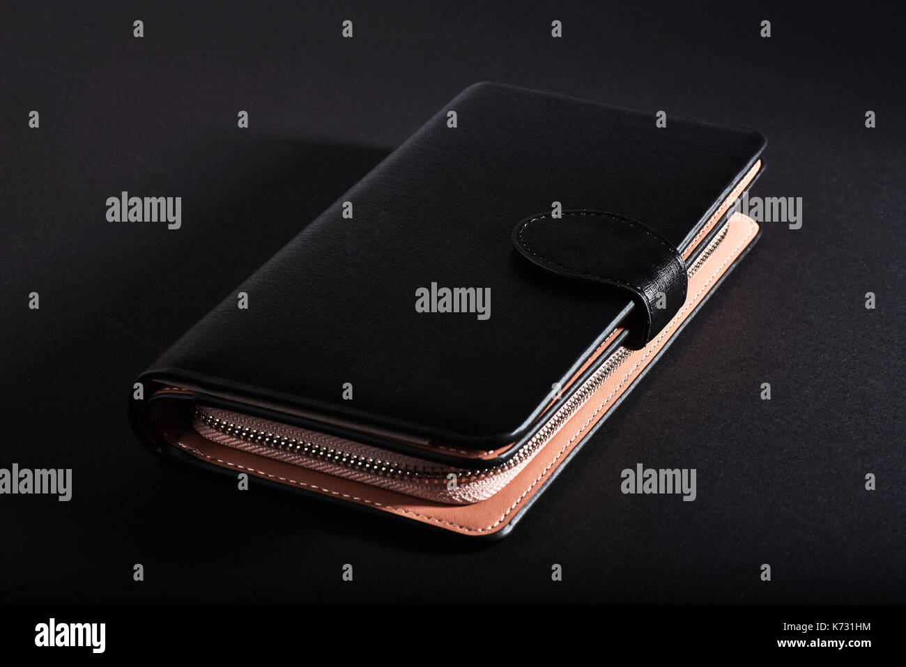 black wallet, isolated on a black background. Stock Photo
