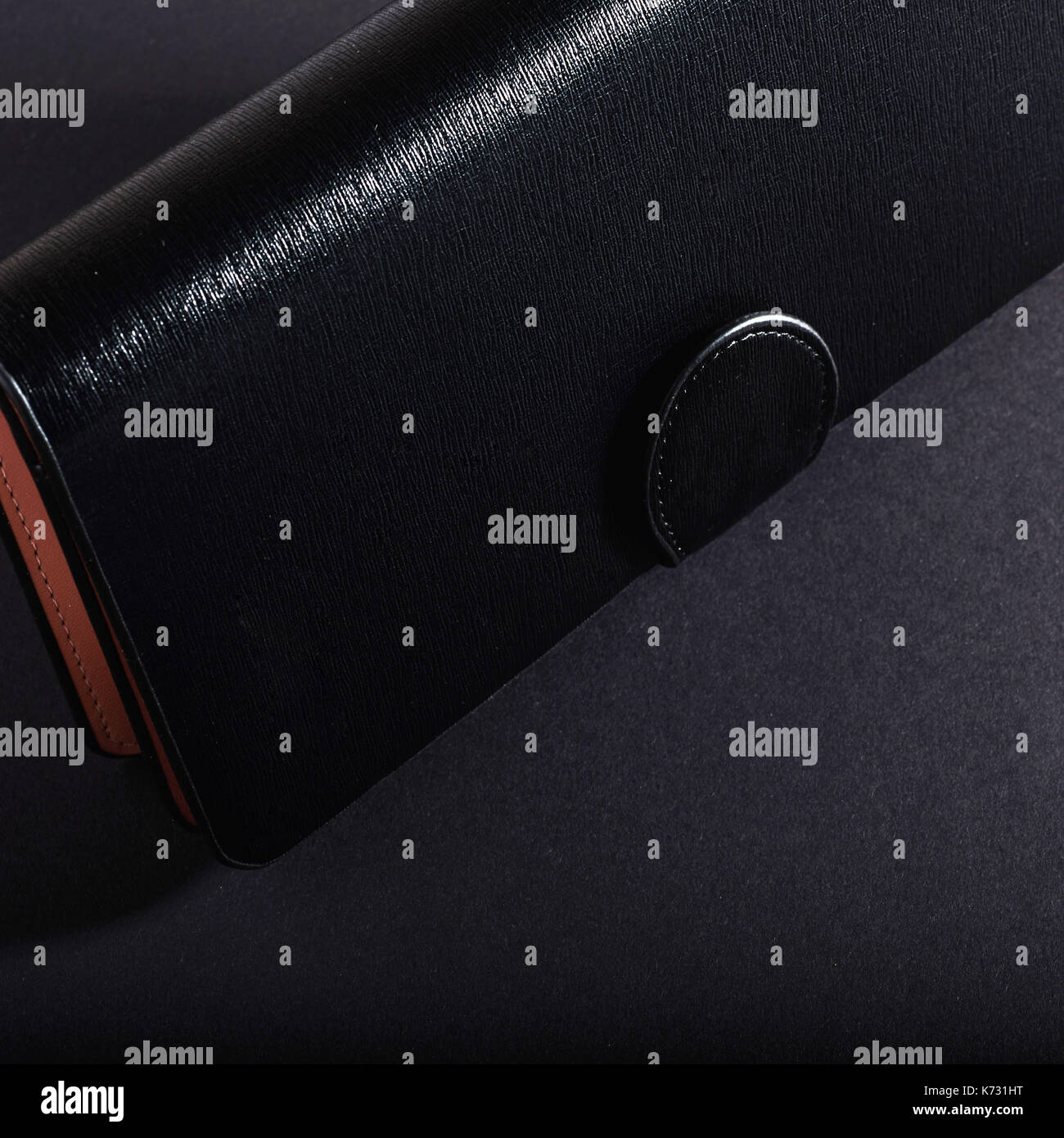 black wallet, isolated on a black background. Stock Photo