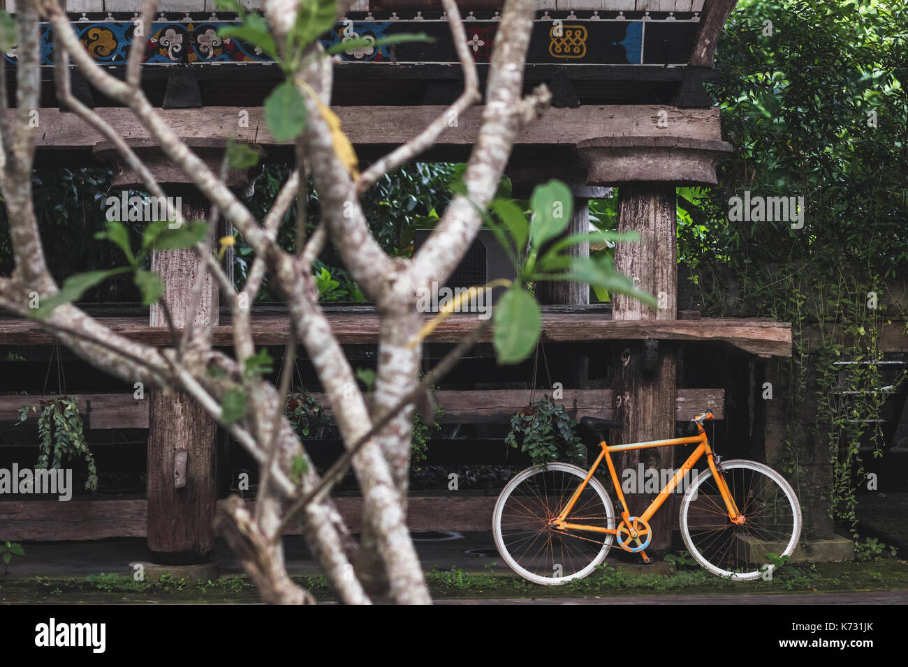 Old fixie bicycle as decoration of hotel in village rustic style in Bali tropical nature Stock Photo