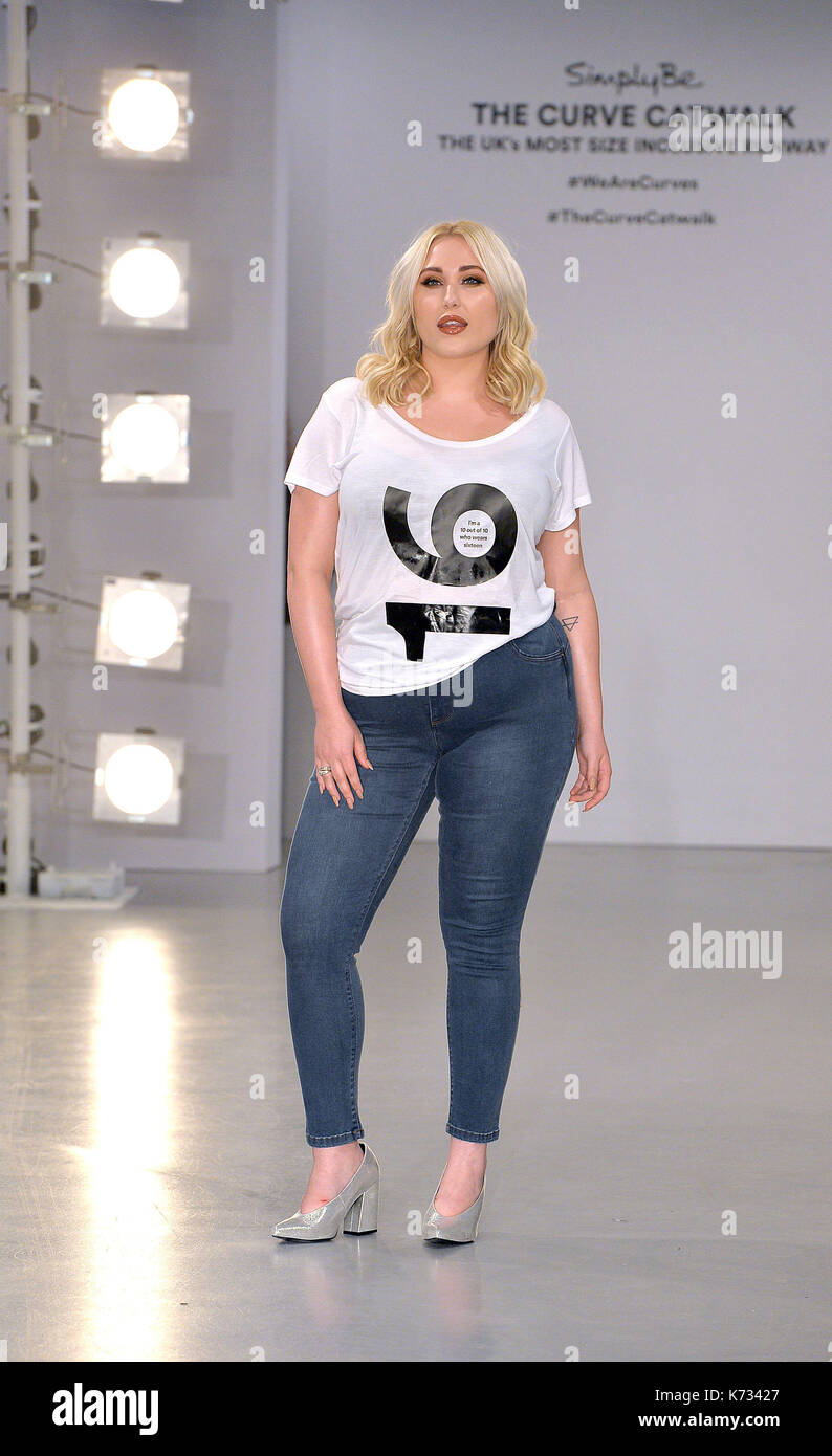 Model, Hayley Hasselhoff, wears a tee shirt with her size printed on it, during a photocall for the 'Curve Catwalk' ahead of London Fashion Week. Stock Photo