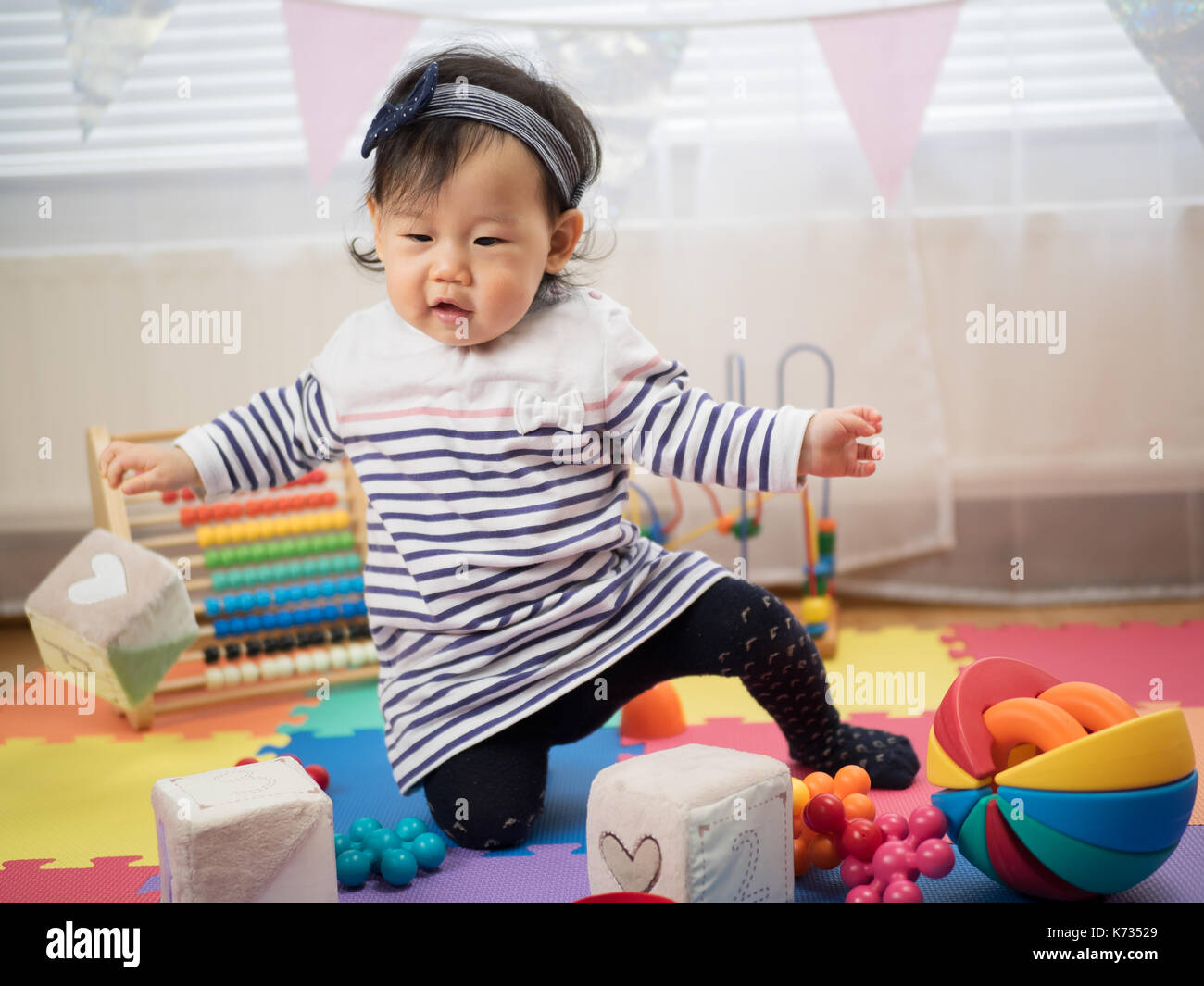 cute smiling baby girl play toy at home Stock Photo - Alamy