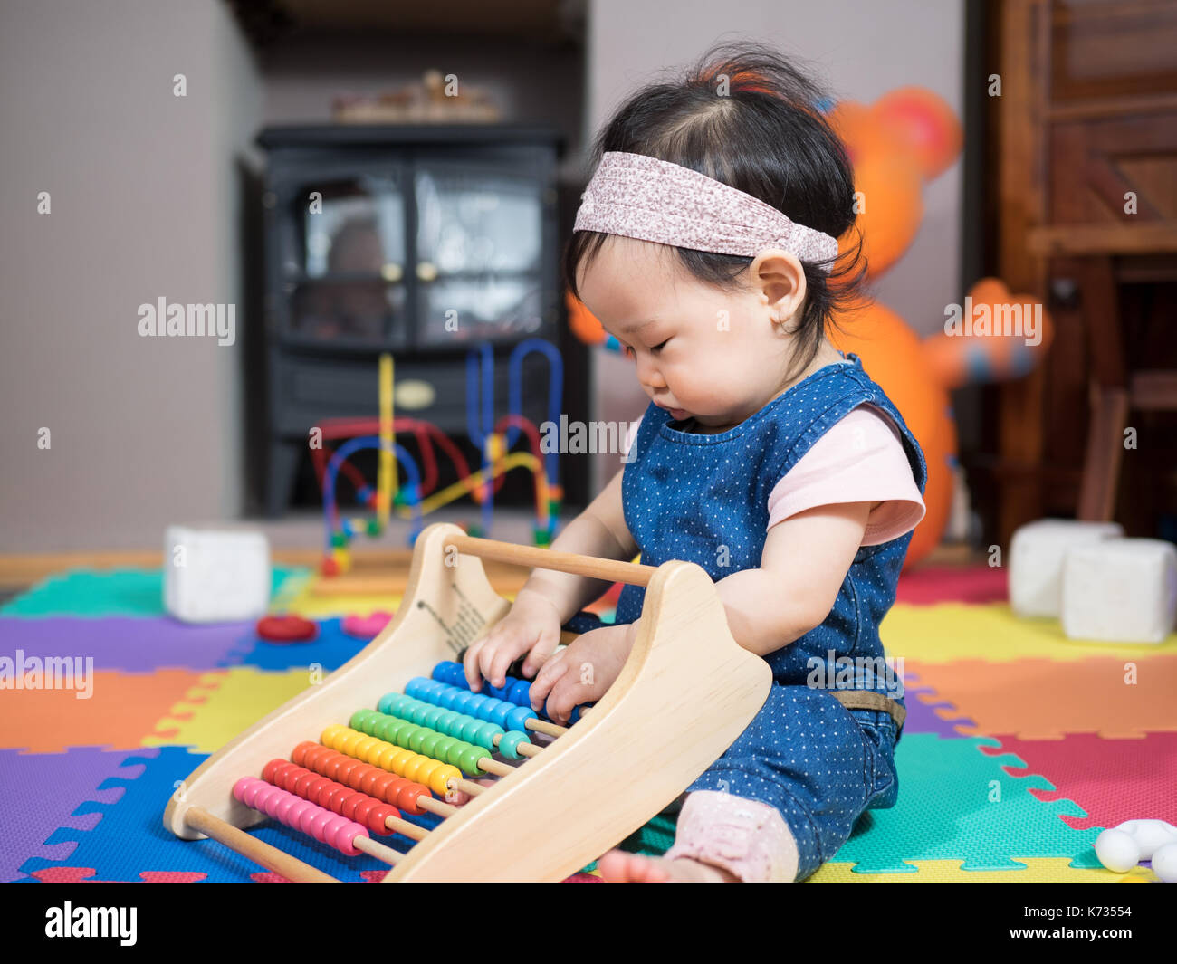 Cute baby girl playing toys at home Stock Photo - Alamy